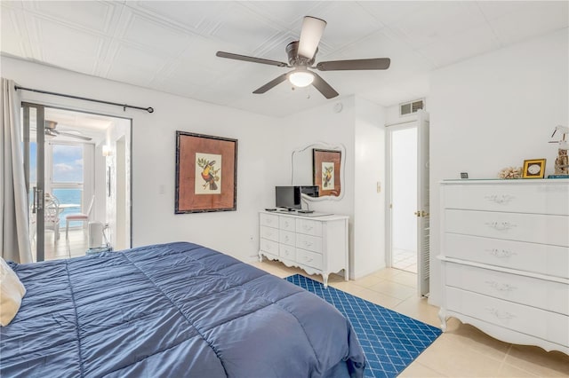 tiled bedroom featuring ceiling fan