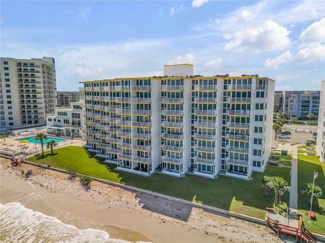 view of building exterior with a view of the beach and a water view