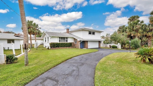 split level home featuring a garage and a front yard