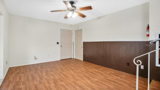 empty room featuring ceiling fan and light hardwood / wood-style floors