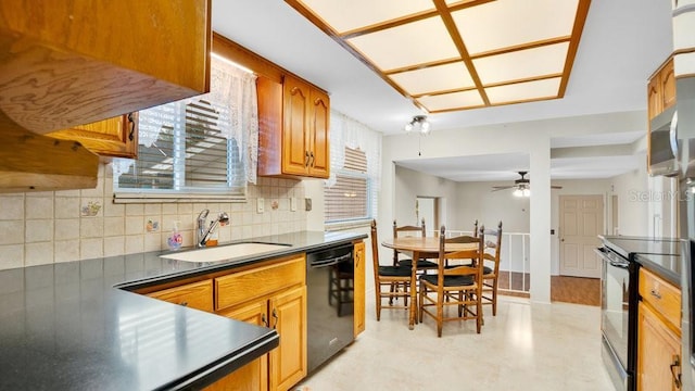 kitchen featuring ceiling fan, black appliances, tasteful backsplash, and sink