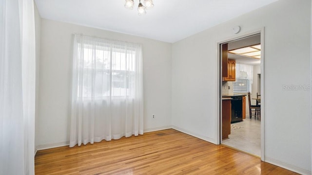 spare room with light hardwood / wood-style flooring