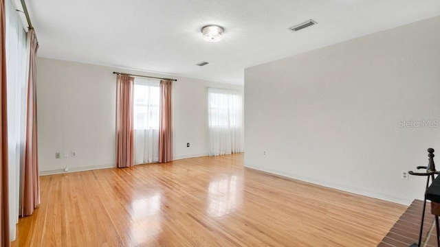 empty room featuring a textured ceiling and light hardwood / wood-style flooring