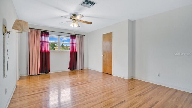 empty room featuring ceiling fan and light wood-type flooring