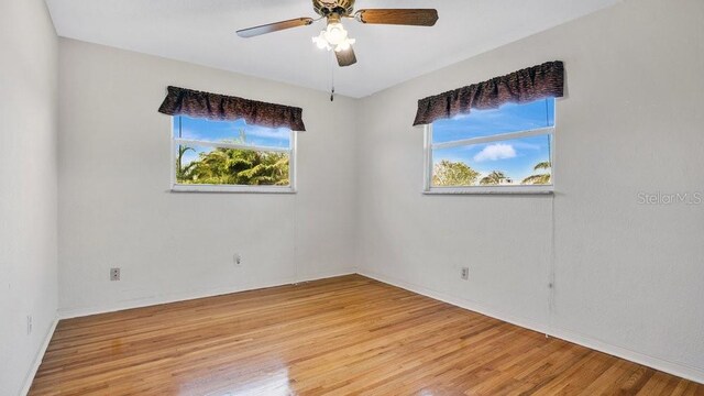 unfurnished room featuring light hardwood / wood-style floors and ceiling fan