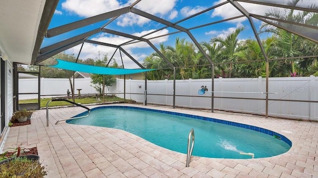 view of pool featuring a patio area and glass enclosure