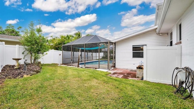 view of yard with glass enclosure and a fenced in pool