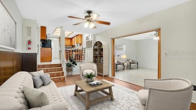 living room with ceiling fan and light wood-type flooring