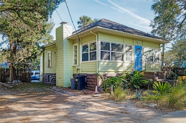 view of side of property with a sunroom