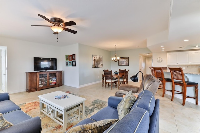 living room featuring light tile patterned floors and ceiling fan with notable chandelier