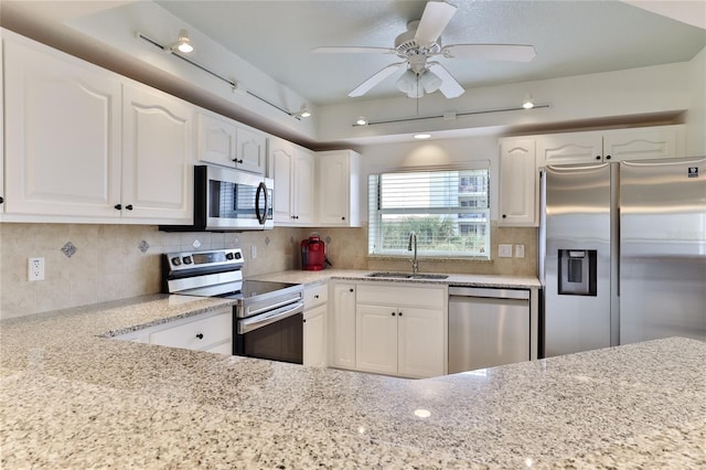 kitchen with decorative backsplash, sink, white cabinets, and stainless steel appliances