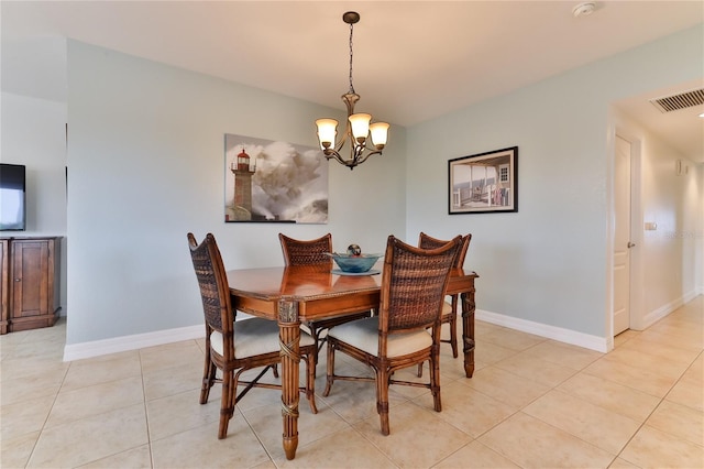 tiled dining space with a notable chandelier