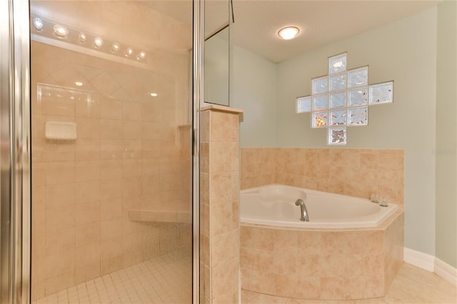 bathroom with tile patterned flooring and independent shower and bath