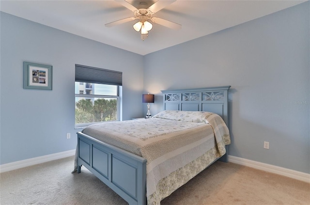 bedroom featuring ceiling fan and light carpet