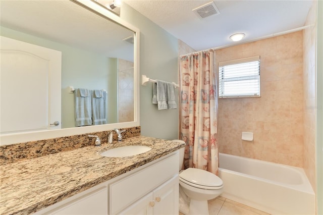 full bathroom featuring shower / bath combo, tile patterned floors, vanity, a textured ceiling, and toilet