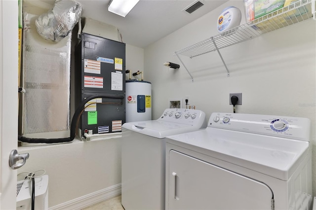 washroom featuring water heater and washing machine and clothes dryer