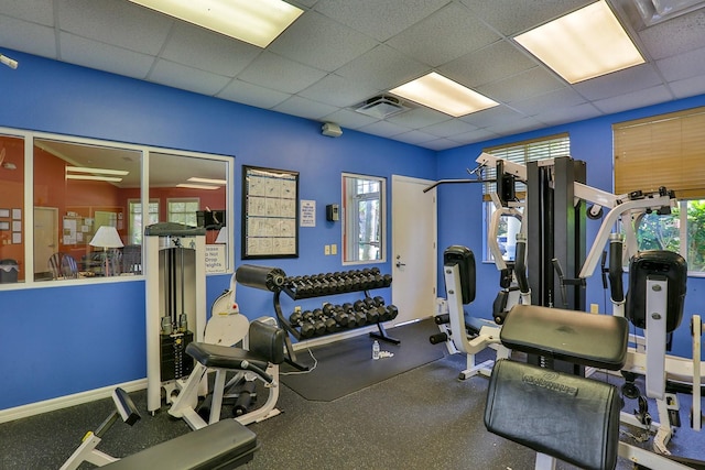 gym with a paneled ceiling