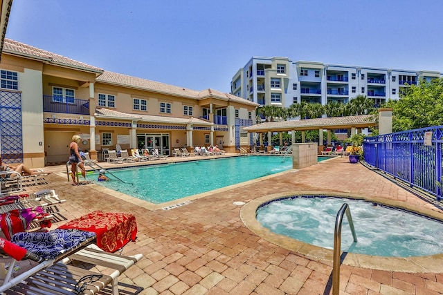 view of swimming pool with a patio and a hot tub