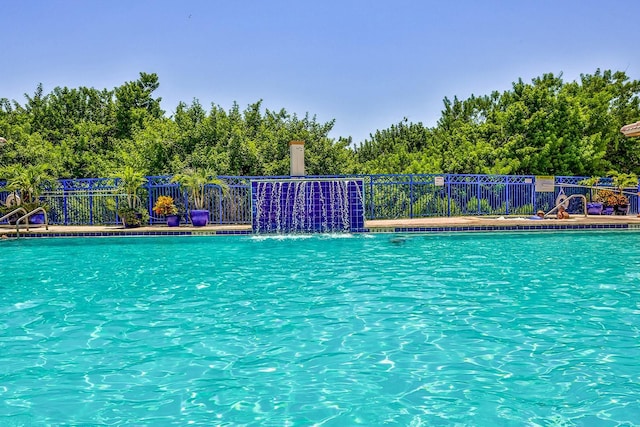 view of pool with pool water feature