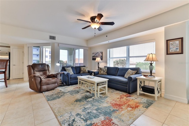 tiled living room with ceiling fan