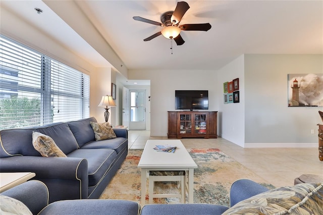 tiled living room featuring ceiling fan