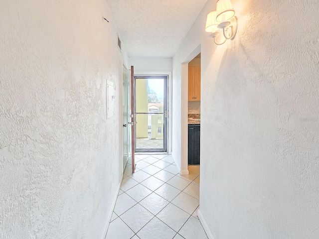 3606 S Peninsula Dr Unit 404, Port Orange, FL 32127 - corridor with light tile patterned floors, a textured wall, and a textured ceiling