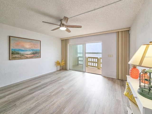 3606 S Peninsula Dr Unit 404, Port Orange, FL 32127 - unfurnished room with wood finished floors, ceiling fan, and a textured ceiling