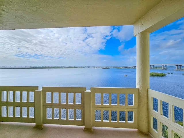 exterior space featuring a balcony and a water view