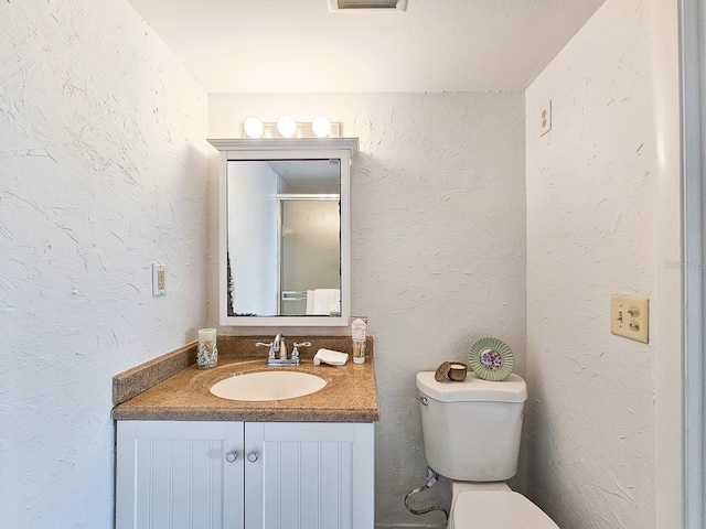 3606 S Peninsula Dr Unit 404, Port Orange, FL 32127 - bathroom featuring vanity and a textured wall