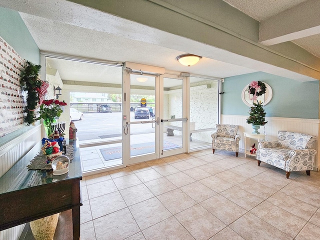 3606 S Peninsula Dr Unit 404, Port Orange, FL 32127 - community lobby with a textured ceiling and a wainscoted wall