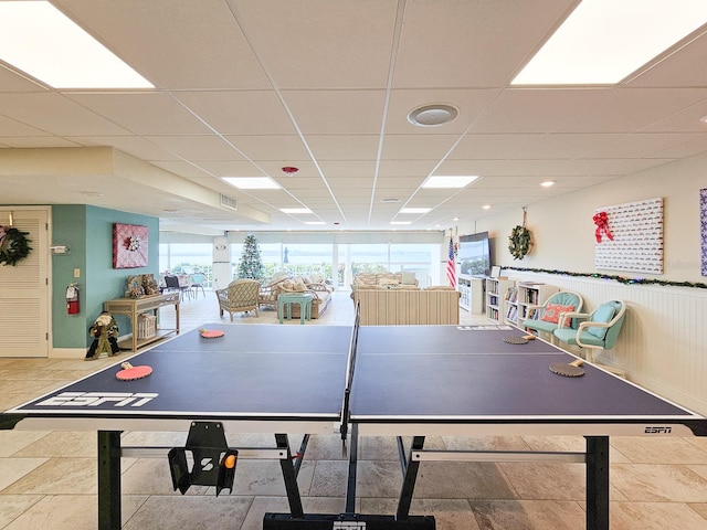 playroom with a paneled ceiling