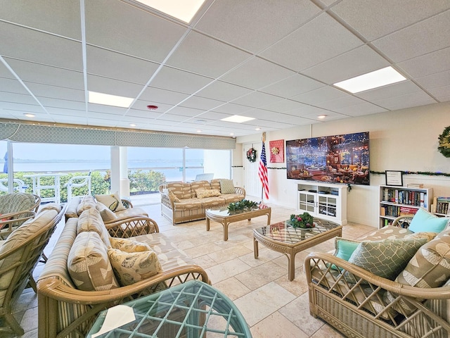 tiled living room featuring a paneled ceiling