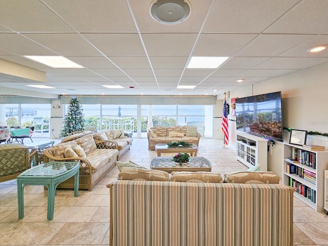 living room featuring a drop ceiling