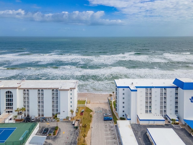 aerial view with a water view and a view of the beach