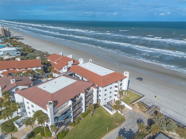 birds eye view of property featuring a view of the beach and a water view