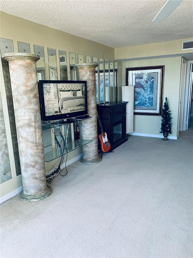 carpeted living room featuring a textured ceiling