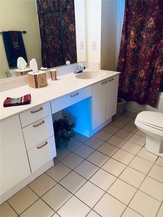 bathroom featuring walk in shower, tile patterned flooring, vanity, and toilet