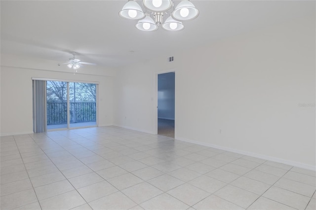 unfurnished room with ceiling fan with notable chandelier and light tile patterned floors