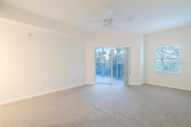 carpeted spare room with ceiling fan