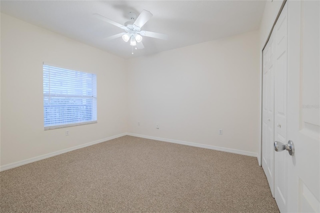 interior space featuring carpet floors and ceiling fan