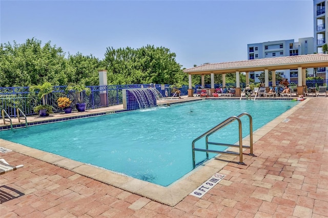 view of pool with pool water feature and a patio