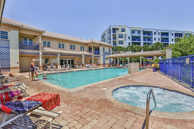 view of pool featuring a patio area and a community hot tub