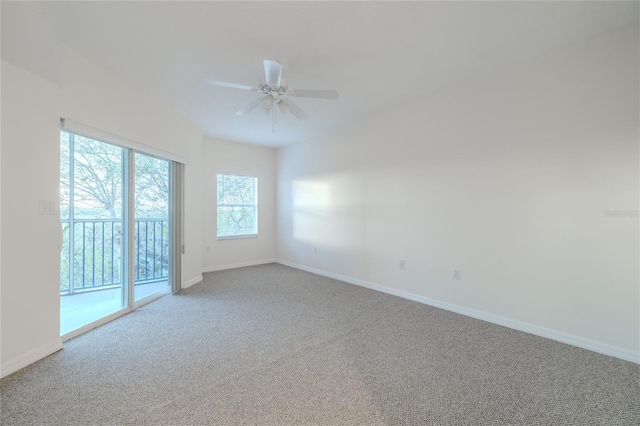 carpeted spare room with ceiling fan