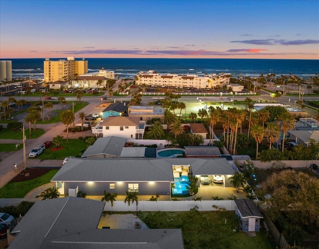 aerial view at dusk with a water view