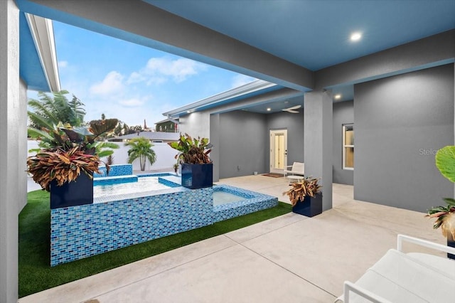 view of swimming pool featuring a patio and a hot tub