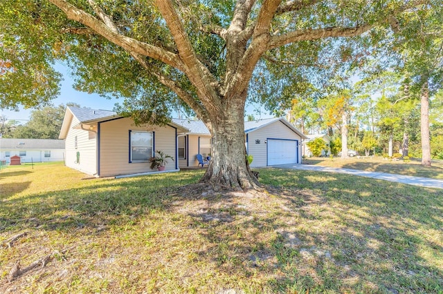 ranch-style home featuring an outbuilding, a front lawn, and a garage