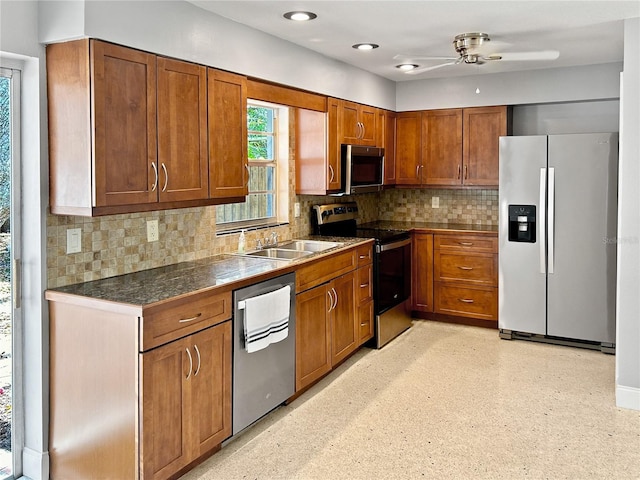 kitchen with tasteful backsplash, ceiling fan, sink, and appliances with stainless steel finishes