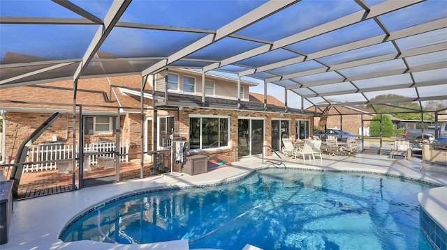 view of pool featuring a patio area and glass enclosure