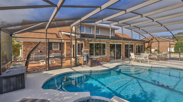 view of swimming pool featuring a patio and a lanai