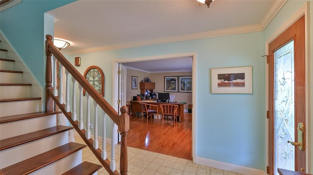 foyer entrance featuring crown molding and light hardwood / wood-style floors